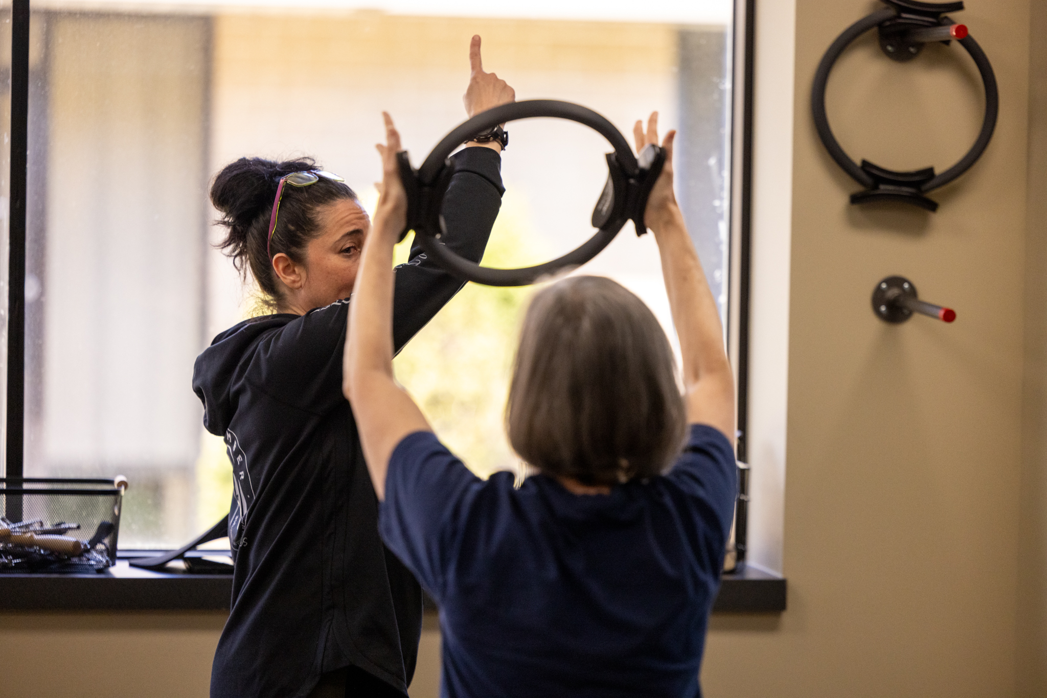 Precision Pilates Client Using Magic Circle