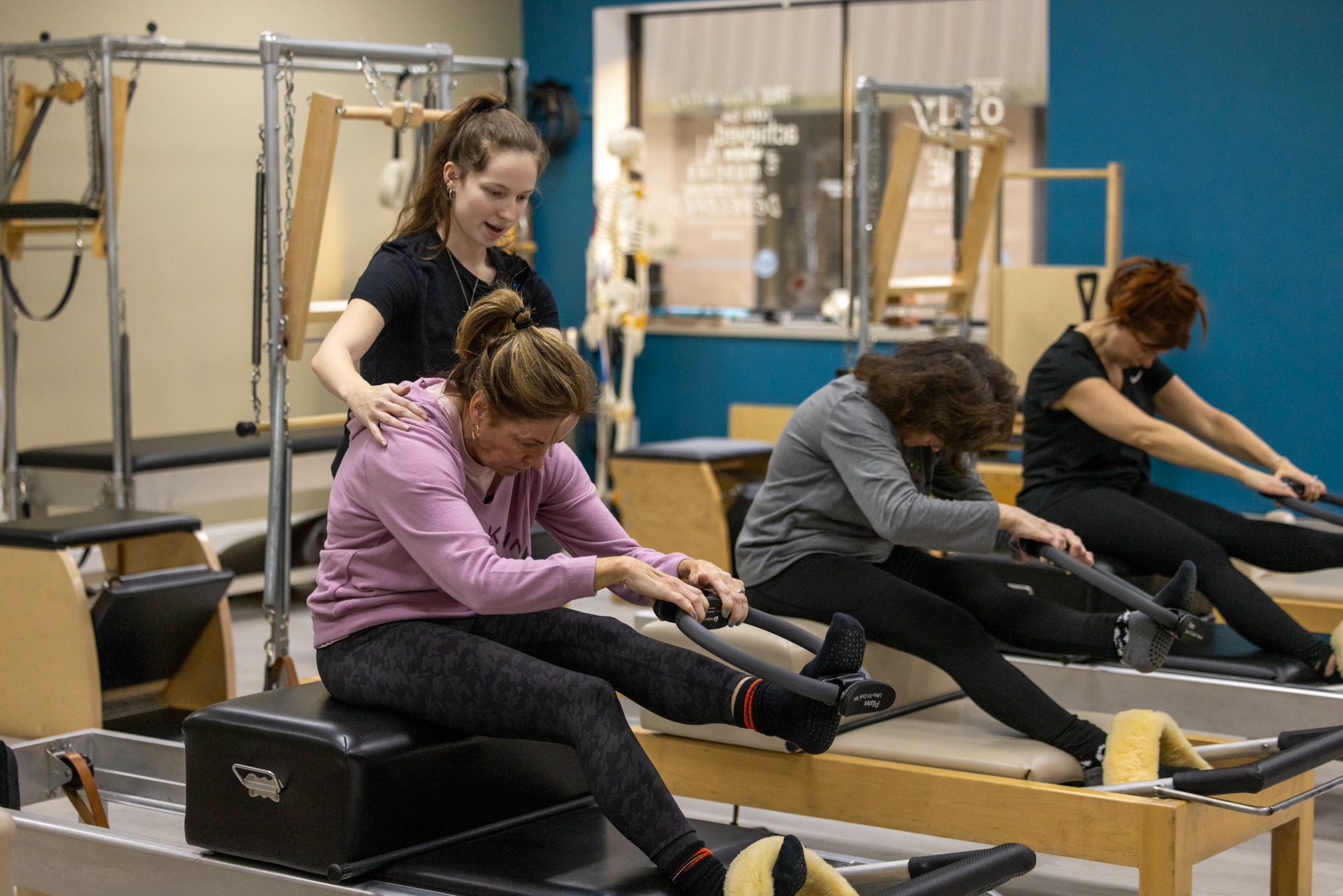 Pilates instructor teaching reformer Pilates at Precision Pilates Nesconset