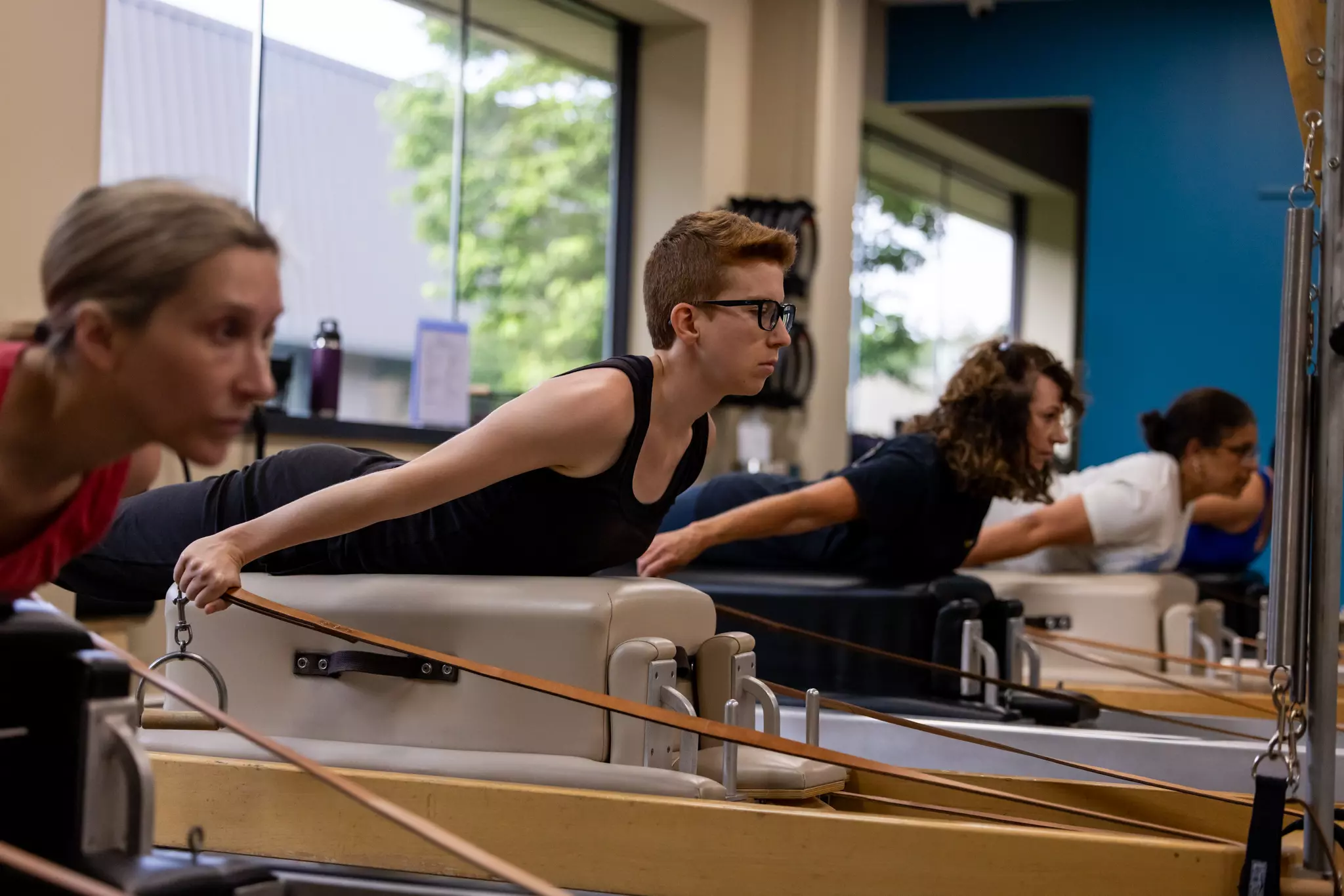 Precision Pilates Clients on a Reformer