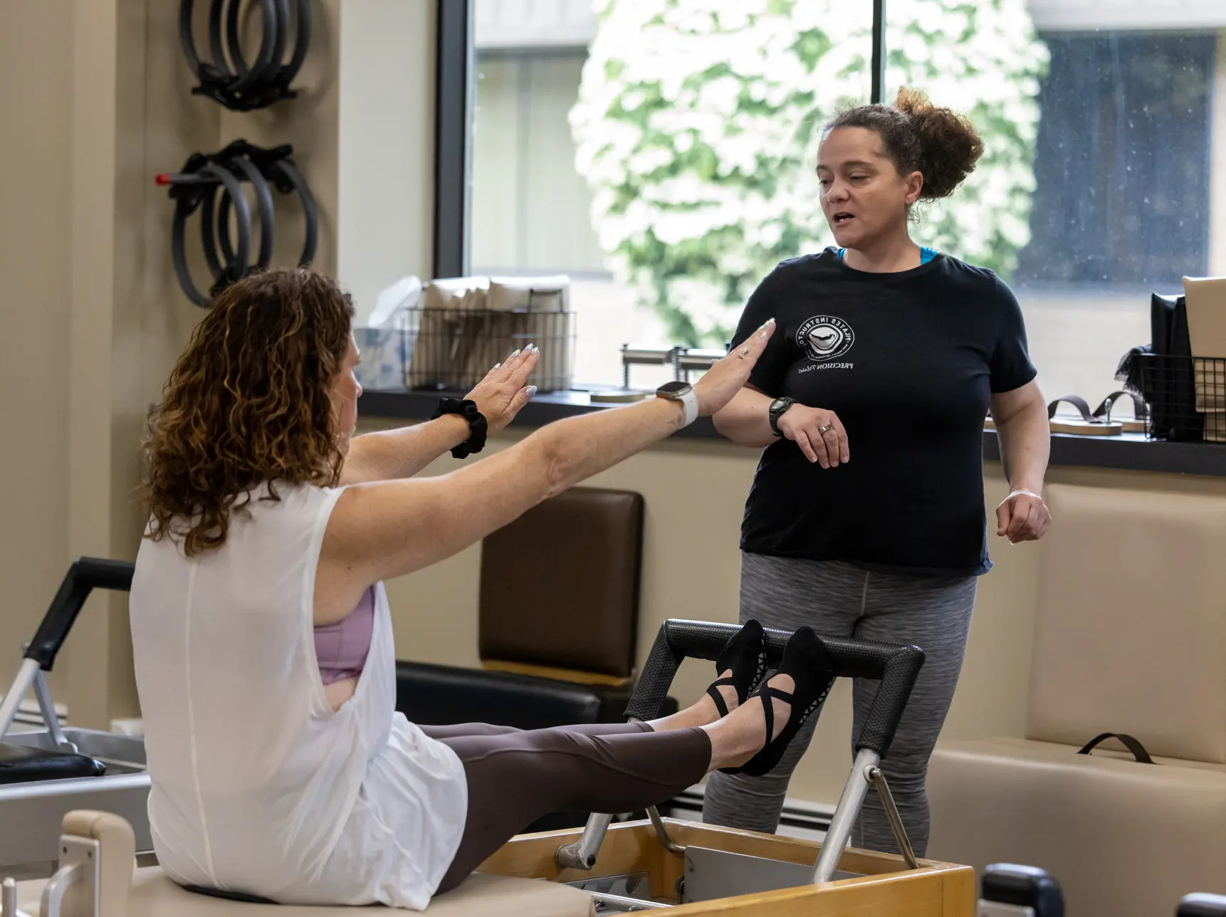 Amy Hirsch teaching a client on a reformer at Precision Pilates Nesconset