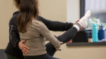 Pilates instructor working with a prenatal client on the reformer