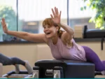 Happy Wowan trying a new exercise on the Reformer during a Pilates Party at Precision Pilates in Smithtonw