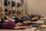 Precision Pilates clients using the tower equipment.