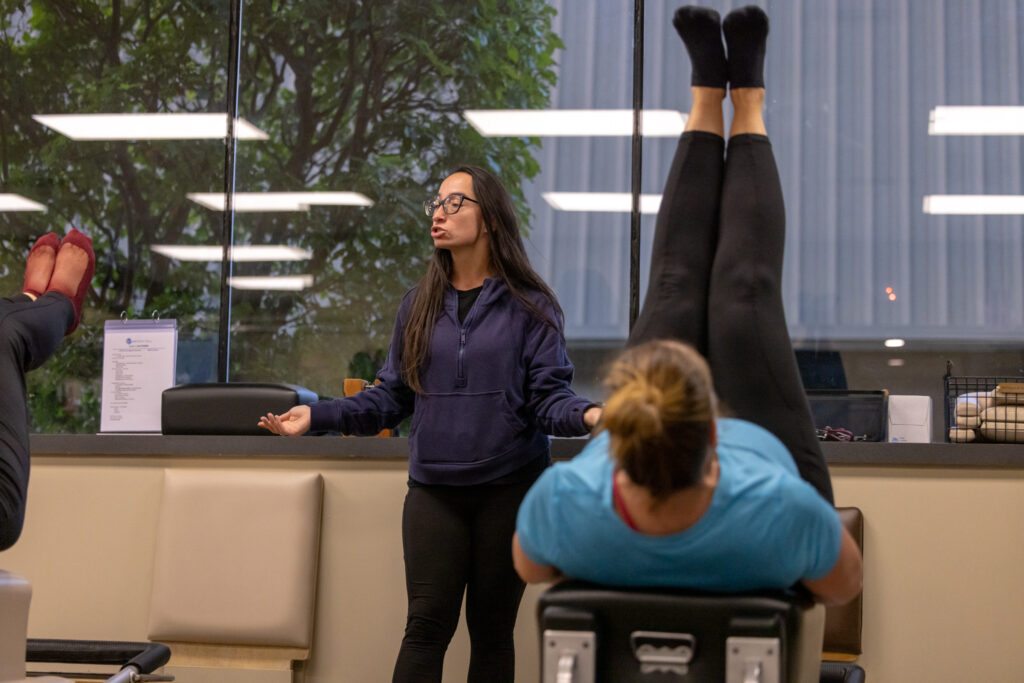 Pilates Instructor Teaching a Classical Reformer Class at Precision Pilates Nesconset