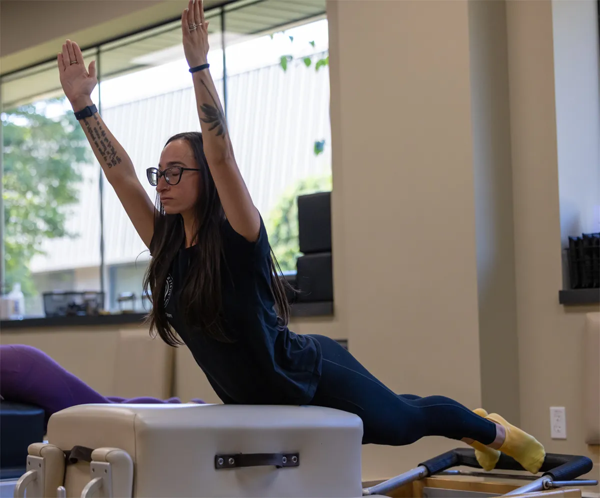 Student doing Pilates on the reformer